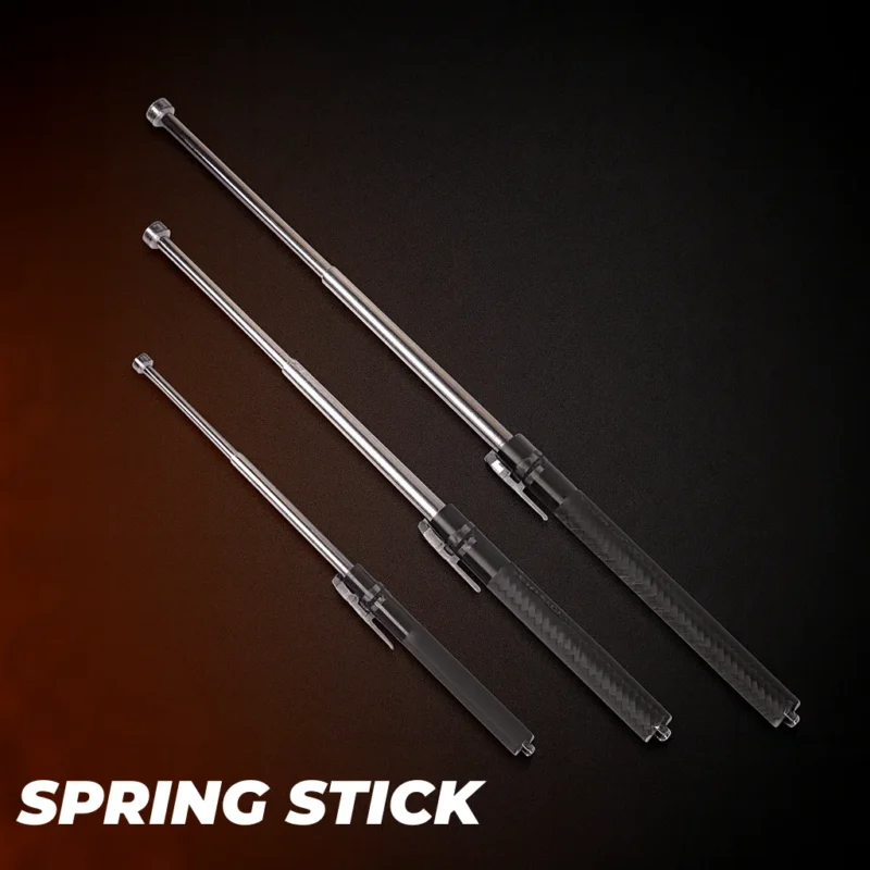 Three stainless steel telescopic batons in small/medium/large with black textured grips, on a dark studio background with warm rim light (wholesale display).