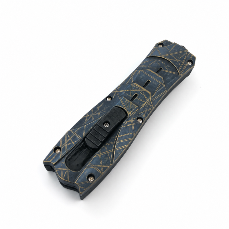 Midnight Brass Widmanstatten sculpted-handle OTF automatic knife shown closed on white