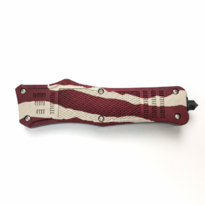 Burgundy Ivory Torn Paper Layers waisted-handle OTF automatic knife shown closed on white