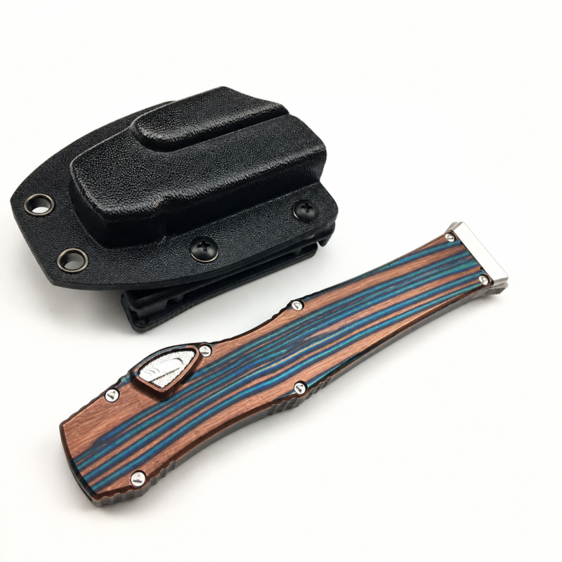 Copper Navy Stratified Horizon aluminum alloy OTF automatic knife closed beside a black sheath on white