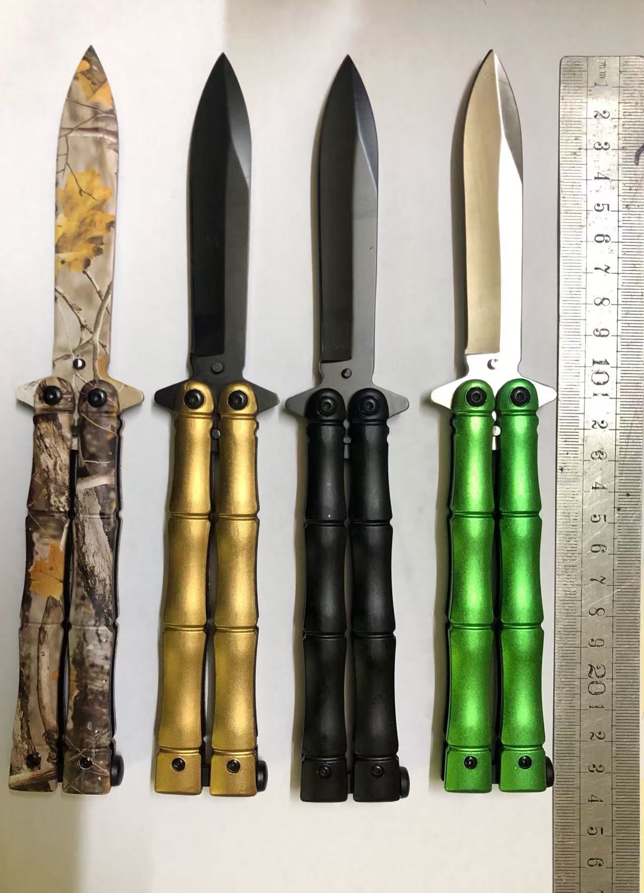 grooved-handle-colors Segmented handle butterfly knife in camo gold black and green