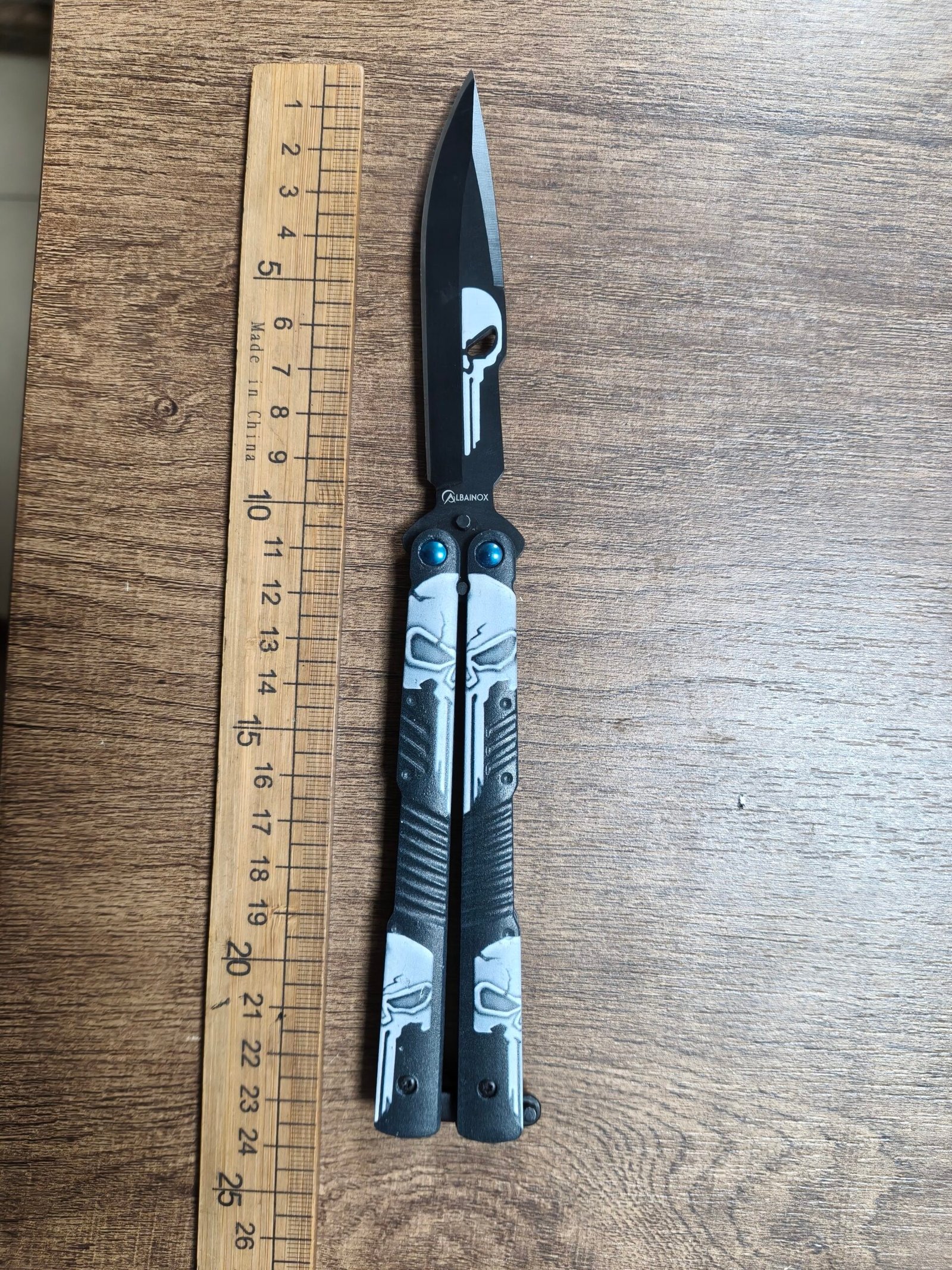 skull-graphic-butterfly-knife Skull graphic butterfly knife with black blade