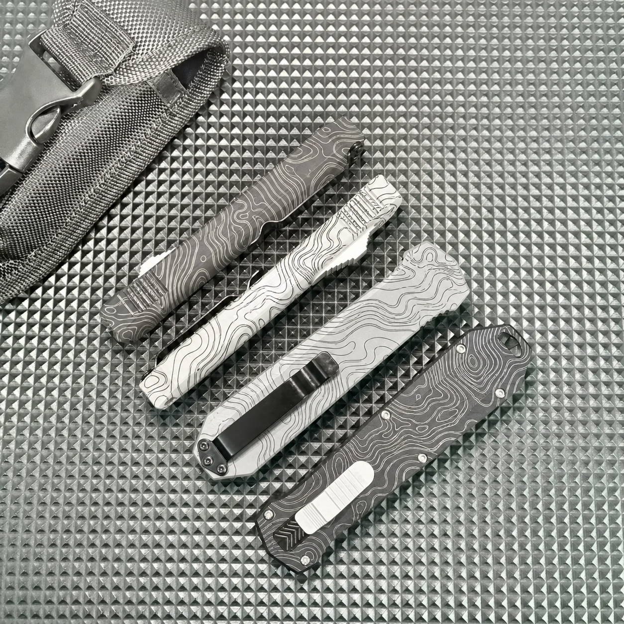 Glacier White Charcoal Topographic OTF Automatic Knife Glacier White Charcoal Topographic OTF automatic knife with face slider and hooked tail opening
