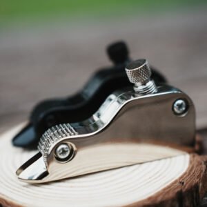 Leather V-groove cutter with metal side plates, pivot fasteners and a knurled adjustment screw