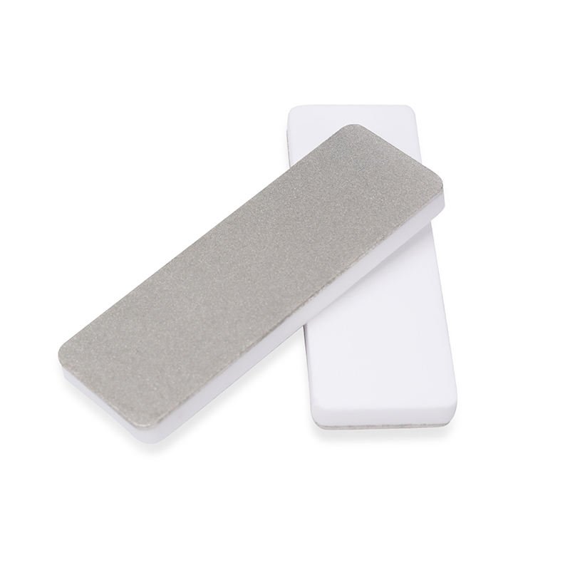 Compact rounded white ceramic sharpening blocks with gray abrasive faces